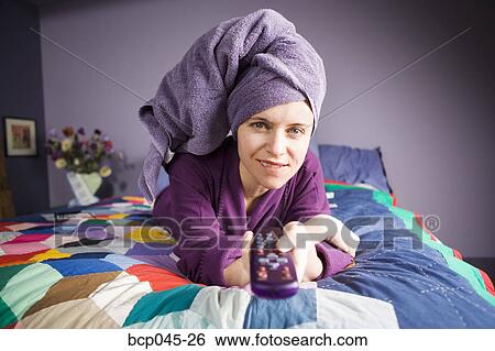 Woman holding remote control View Large Photo Image Stock Photograph - Woman holding remote control. Fotosearch