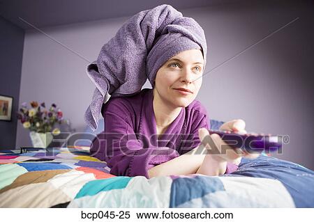 Woman holding remote control View Large Photo Image Stock Photography - Woman holding remote control. Fotosearch