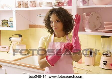 Woman putting on rubber gloves View Large Photo Image Picture - Woman putting on rubber gloves. Fotosearch