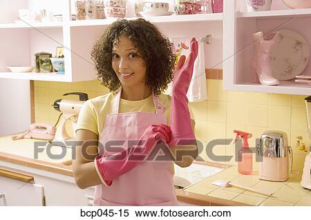 Woman putting on rubber gloves View Large Photo Image Stock Photography - Woman putting on rubber gloves. Fotosearch