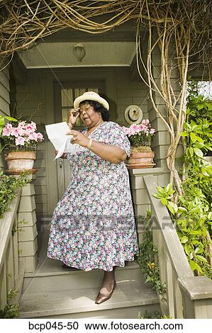 Woman reading a letter View Large Photo Image Stock Image - Woman reading a letter. Fotosearch