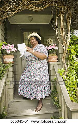 Woman reading a letter View Large Photo Image Stock Image - Woman reading a letter. Fotosearch