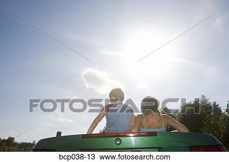 Boy and girl in backseat of convertible car View Large Photo Image Stock Image - Boy and girl in backseat of convertible car. Fotosearch