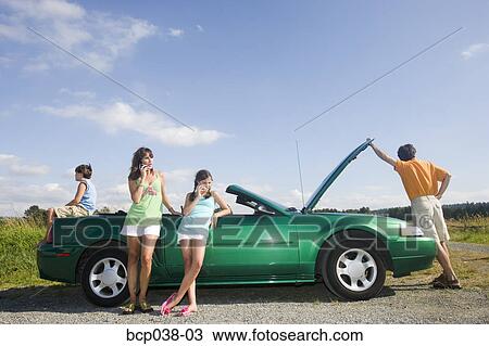 Stock Image - Family coping with car breakdown. Fotosearch