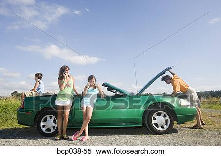 Family coping with car breakdown View Large Photo Image Stock Photography - Family coping with car breakdown. Fotosearch