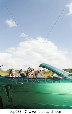 Stock Photo - Family riding in convertible car. Fotosearch