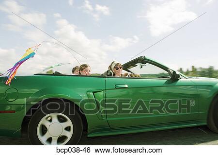 Family riding in convertible car View Large Photo Image Stock Photograph - Family riding in convertible car. Fotosearch