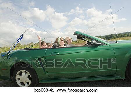 Family riding in convertible car View Large Photo Image Stock Photography - Family riding in convertible car. Fotosearch