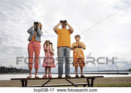 Family using binoculars View Large Photo Image Stock Photo - Family using binoculars. Fotosearch