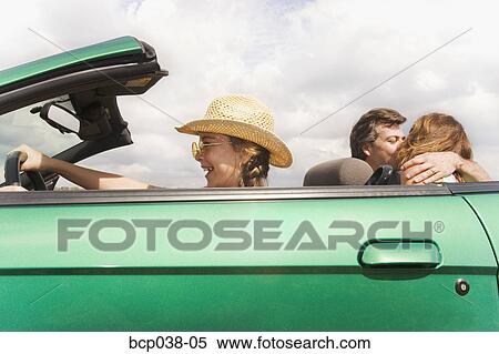 Girl pretending to drive while parents kiss View Large Photo Image Stock Photography - Girl pretending to drive while parents kiss. Fotosearch