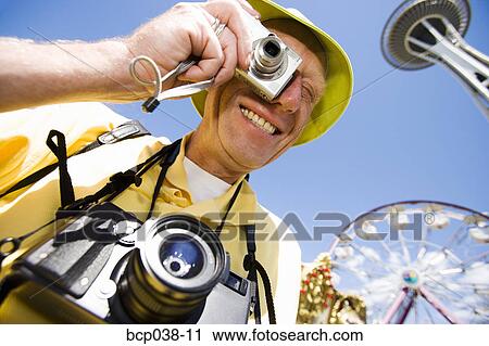 Tourist taking a photo View Large Photo Image Stock Image - Tourist taking a photo. Fotosearch