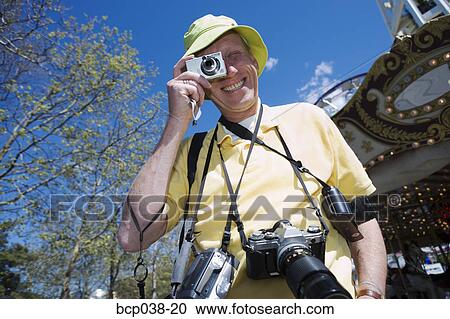 Tourist taking a photograph View Large Photo Image Stock Image - Tourist taking a photograph. Fotosearch