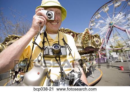 Stock Image - Tourist taking a photograph. Fotosearch