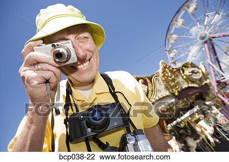 Stock Image - Tourist taking a photograph. Fotosearch