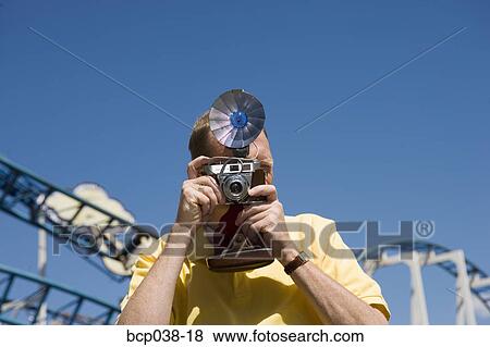 Tourist taking a photograph View Large Photo Image Stock Photo - Tourist taking a photograph. Fotosearch