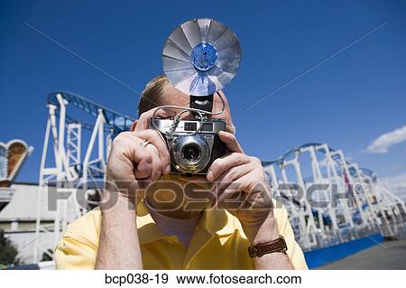 Tourist taking a photograph View Large Photo Image Stock Photo - Tourist taking a photograph. Fotosearch