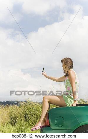 Woman taking photo with mobile phone View Large Photo Image Stock Image - Woman taking photo with mobile phone. Fotosearch
