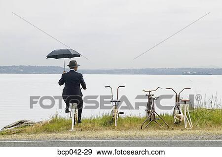 Businessman with row of stationary bikes View Large Photo Image Stock Photo - Businessman with row of stationary bikes. Fotosearch