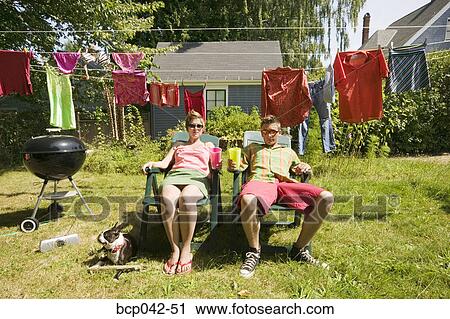 Couple lounging in back yard View Large Photo Image Stock Image - Couple lounging in back yard. Fotosearch