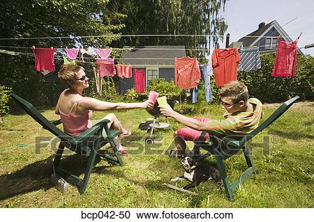 Couple toasting in back yard View Large Photo Image Stock Image - Couple toasting in back yard. Fotosearch