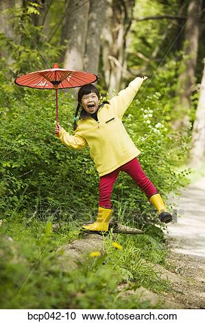 Happy little girl posing with parasol View Large Photo Image Stock Image - Happy little girl posing with parasol. Fotosearch