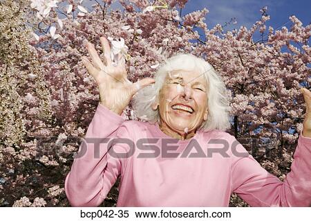 Joyful woman throwing petals View Large Photo Image Stock Photography - Joyful woman throwing petals. Fotosearch