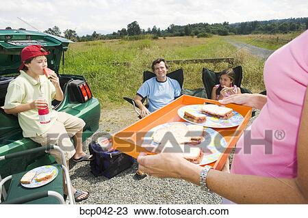 Mom serving picnic lunch to family View Large Photo Image Stock Image - Mom serving picnic lunch to family. Fotosearch