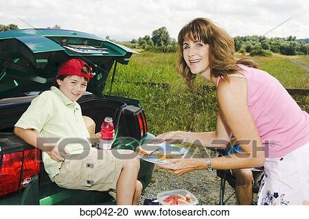 Mother and son with picnic food View Large Photo Image Stock Image - Mother and son with picnic food. Fotosearch