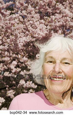 Smiling woman with flowering tree View Large Photo Image Picture - Smiling woman with flowering tree. Fotosearch
