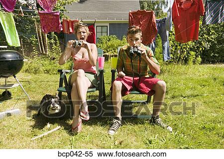 Surprised couple with camera and binoculars View Large Photo Image Stock Photography - Surprised couple with camera and binoculars. Fotosearch