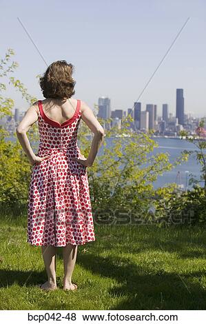 Woman looking at city skyline View Large Photo Image Stock Photo - Woman looking at city skyline. Fotosearch