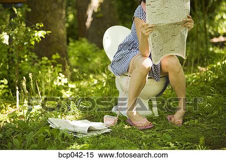 Woman sitting on toilet in forest View Large Photo Image Stock Photography - Woman sitting on toilet in forest. Fotosearch