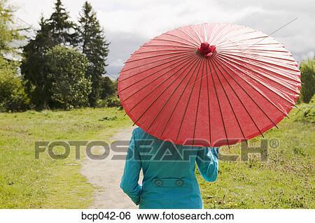 Woman walking in country with parasol View Large Photo Image Stock Photograph - Woman walking in country with parasol. Fotosearch