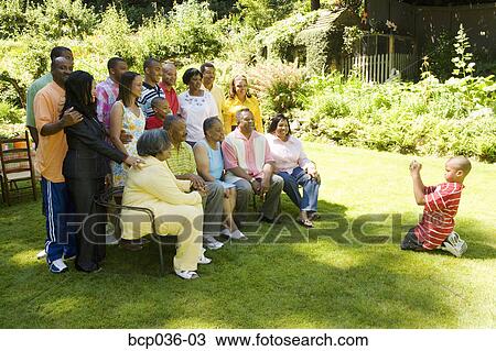 Stock Image - Boy taking family portrait. Fotosearch