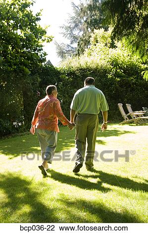 Couple holding hands outdoors View Large Photo Image Stock Image - Couple holding hands outdoors. Fotosearch