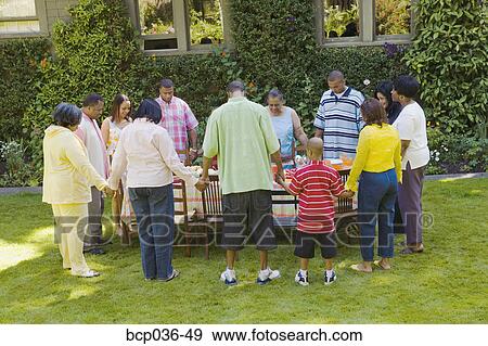 Family holding hands at picnic View Large Photo Image Stock Photo - Family holding hands at picnic. Fotosearch