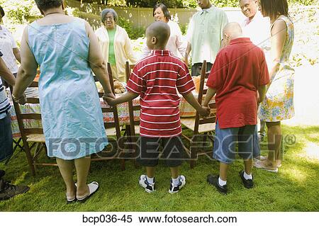 Family holding hands at picnic View Large Photo Image Stock Photography - Family holding hands at picnic. Fotosearch