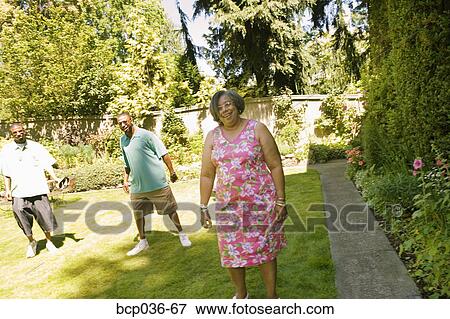 Stock Photo - Family members walking outdoors. Fotosearch