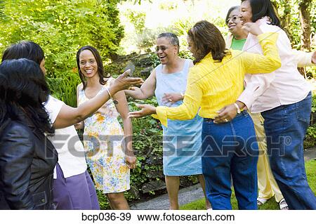 Stock Photo - Female family members hugging. Fotosearch