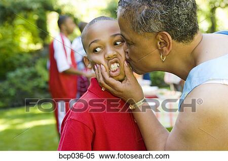Grandmother kissing young boy View Large Photo Image Stock Photography - Grandmother kissing young boy. Fotosearch
