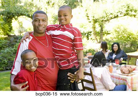 Stock Photography - Males posing at a family picnic. Fotosearch
