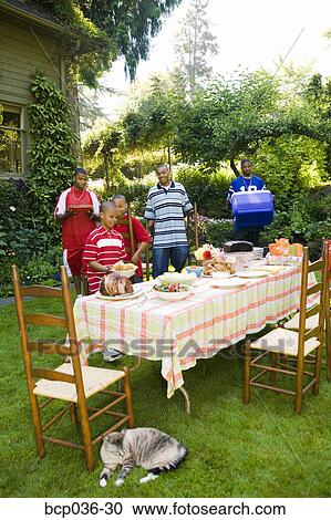 Males preparing for a summer picnic View Large Photo Image Stock Image - Males preparing for a summer picnic. Fotosearch