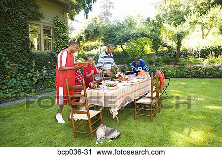 Males preparing for a summer picnic View Large Photo Image Stock Image - Males preparing for a summer picnic. Fotosearch