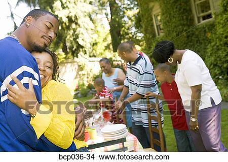 Picture - Man and woman hugging outdoors. Fotosearch