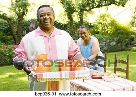 Man carrying drinks for picnic View Large Photo Image Stock Image - Man carrying drinks for picnic. Fotosearch