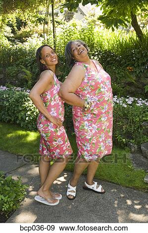 Two women posing for camera View Large Photo Image Stock Photo - Two women posing for camera. Fotosearch