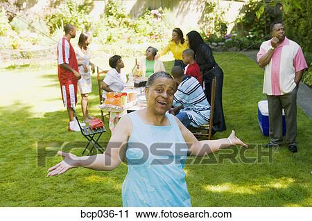 Stock Image - Woman enjoying a family picnic. Fotosearch