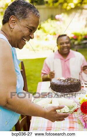Woman enjoying a picnic outdoors View Large Photo Image Stock Photo - Woman enjoying a picnic outdoors. Fotosearch