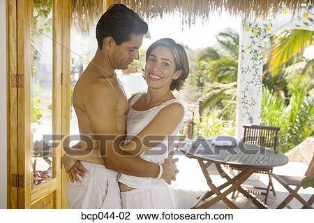 Couple embracing in tropical setting View Large Photo Image Stock Image - Couple embracing in tropical setting. Fotosearch