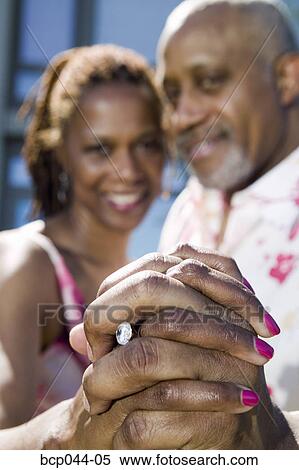 Couple showing off engagement ring View Large Photo Image Stock Photography - Couple showing off engagement ring. Fotosearch